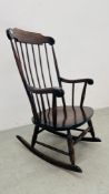 AN OAK STICK BACK ROCKING CHAIR.