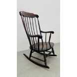 AN OAK STICK BACK ROCKING CHAIR.