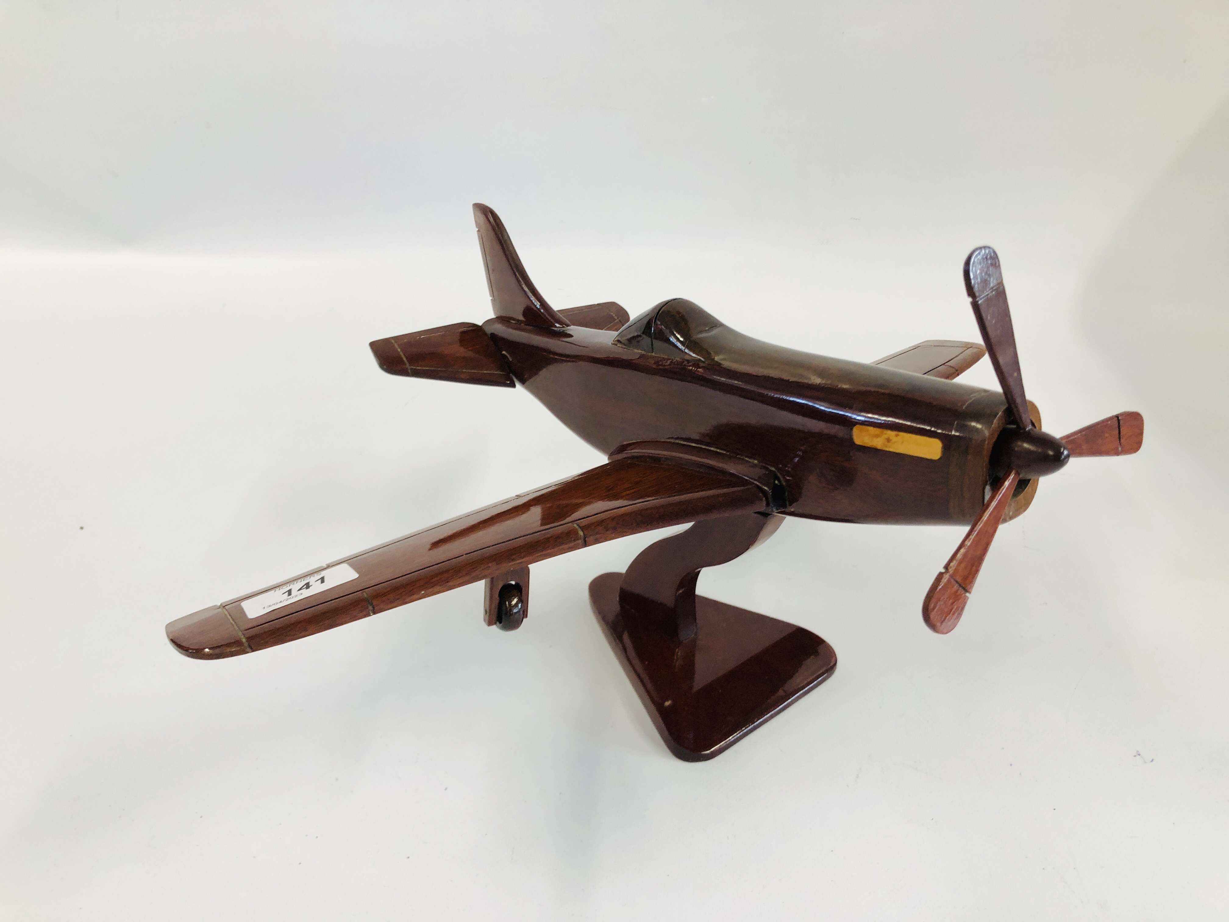 A HAND CRAFTED WOODEN SPITFIRE MODEL.