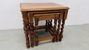 A NEST OF THREE GRADUATED OAK TABLES.