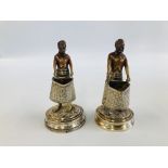 A PAIR OF ANTIQUE ORIENTAL WHITE METAL FIGURES HOLDING LARGE BASKETS ONE MARKED L.C. H 13CM.