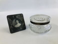 AN ART NOUVEAU STYLE SILVER PHOTO FRAME BIRMINGHAM ALONG WITH SILVER BANDED DRESSING TABLE JAR A/F.