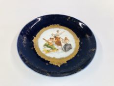 A DECORATIVE CARLSBAD AUSTRIA PLATE WITH TRANSFER PAINTED SCENE OF 3 LADIES WITH INSTRUMENTS