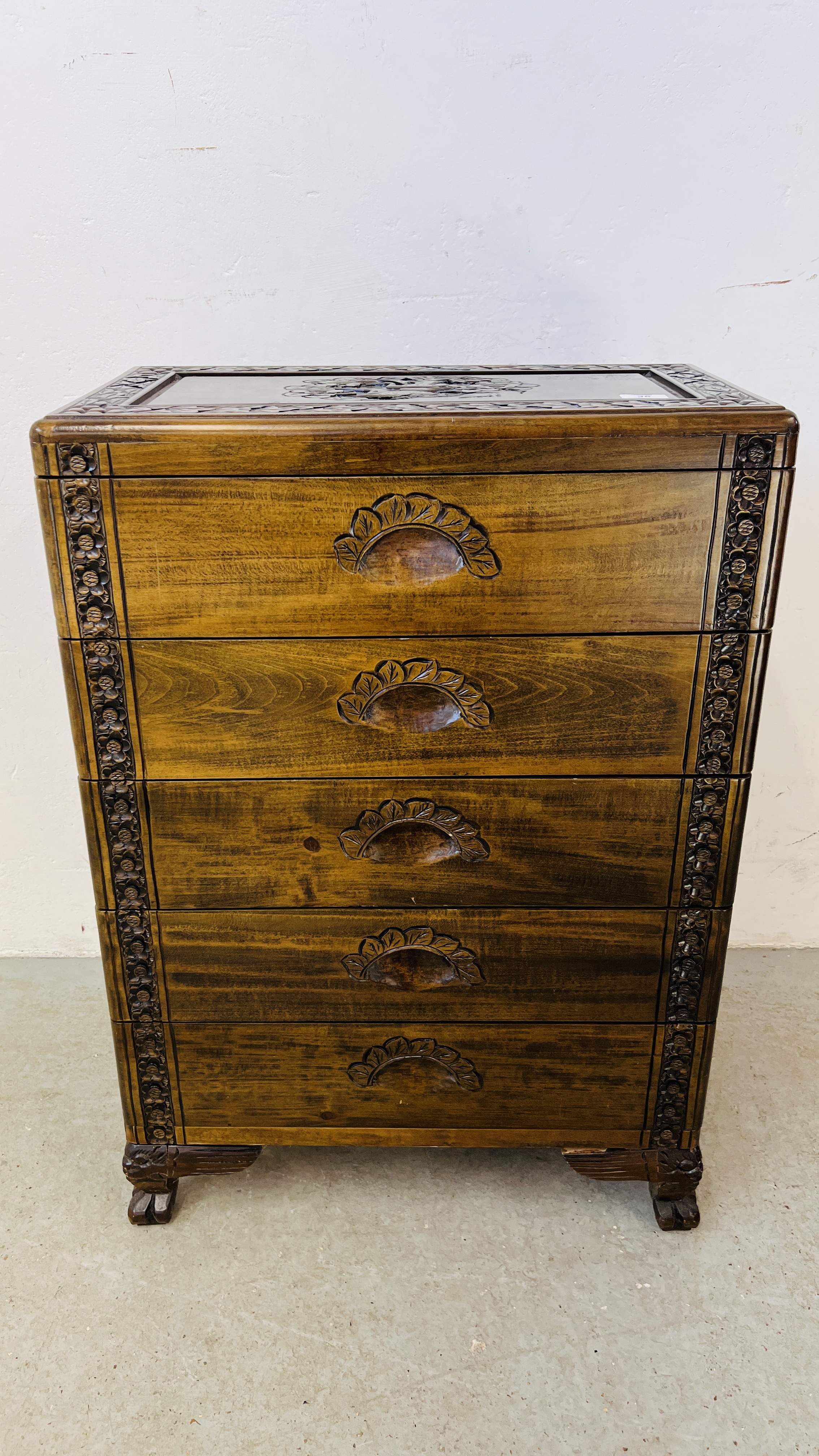 A 5 DRAWER HARDWOOD CHEST WITH A PAIR OF STALKS CARVED TO TOP AND FLORAL DECORATION CARVING - W