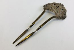 AN ANTIQUE SILVER HAIR PIN,