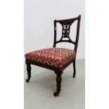 AN EDWARDIAN BEDROOM CHAIR WITH CARVED DETAILING AND UPHOLSTERED SEAT.