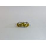 AN UNUSUAL DESIGNER 9CT WHITE GOLD WISHBONE RING SET WITH YELLOW DIAMONDS.