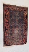 A TRADITIONAL BELOUCH RUG BLUE/ORANGE DESIGN (WORN CONDITION) 135 X 90CM.