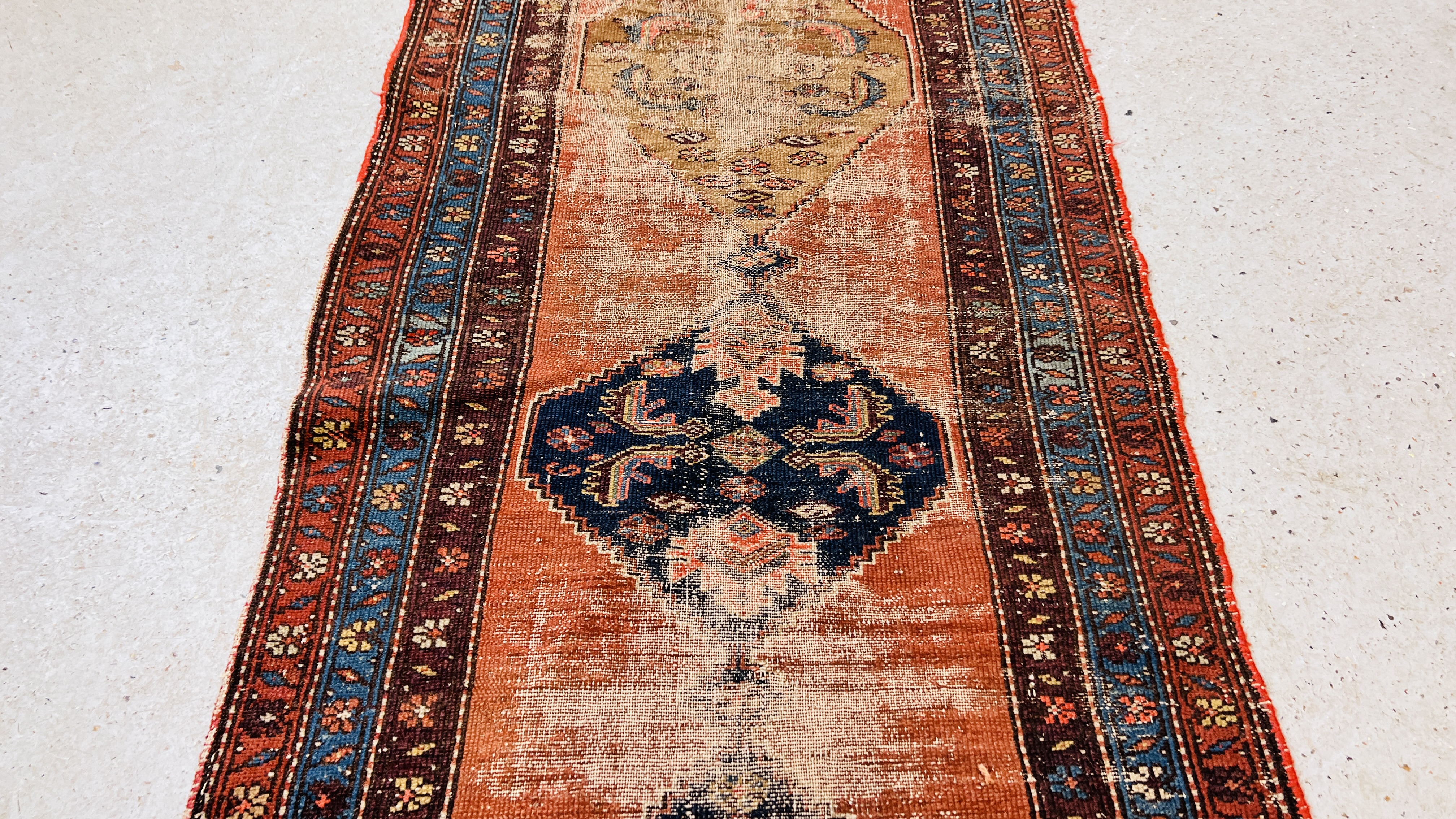 A TRADITIONAL CAUCASIAN RUNNER, THE CENTRAL LOZENGES ON A BRICK RED FIELD, WORN CONDITION. - Image 4 of 11