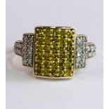 AN UNUSUAL DESIGNER 9CT GOLD RING SET WITH CENTRAL YELLOW DIAMONDS AND WHITE DIAMOND SHOULDERS.
