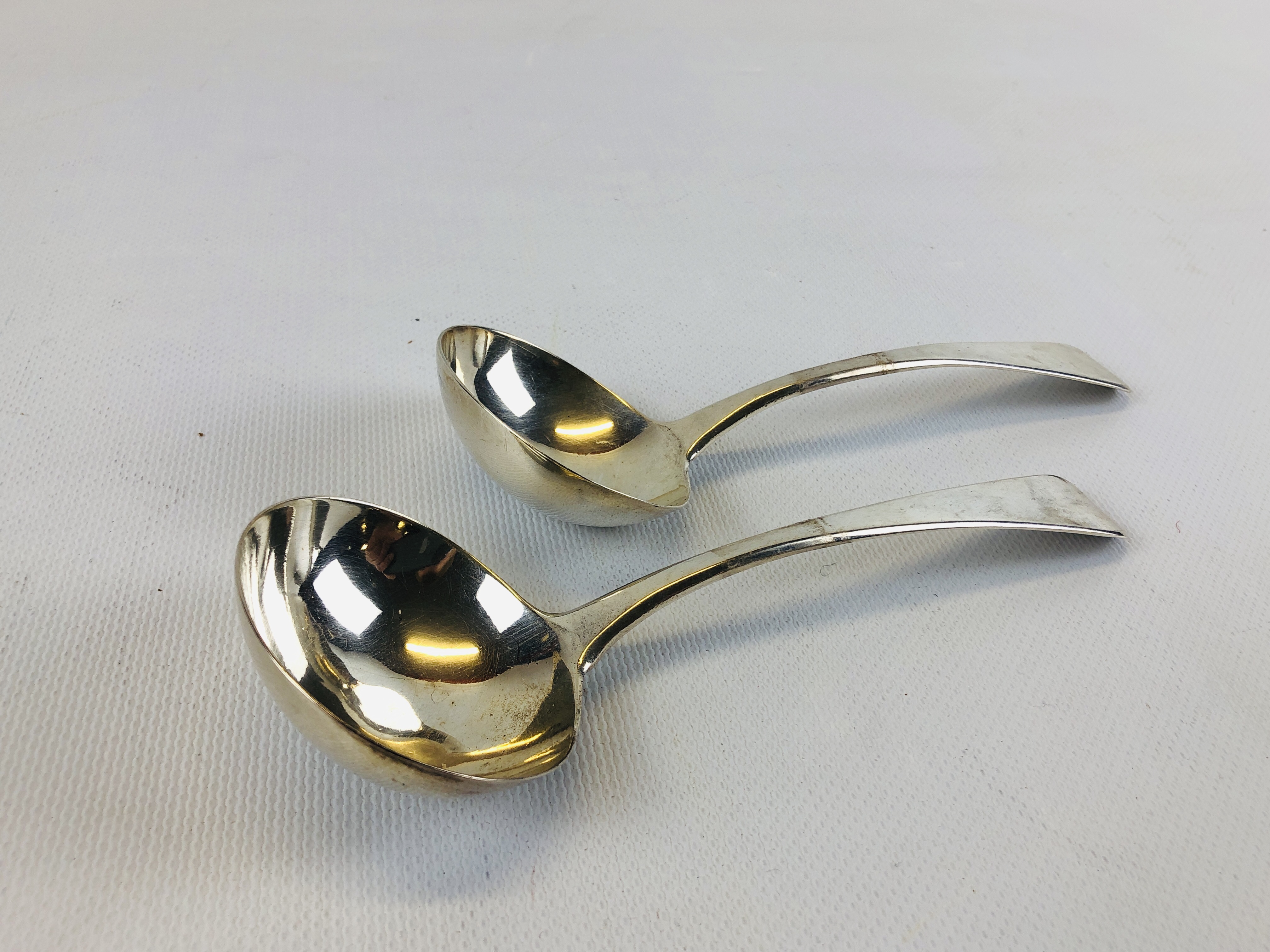 A PAIR OF GEORGE III OLD ENGLISH PATTERN SILVER SAUCE LADLES.