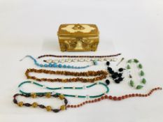 AN ELABORATE RESIN JEWELLERY BOX WITH BEADED NECKLACES ETC. TO INCLUDE RAW AMBER AND GLASS EXAMPLES.