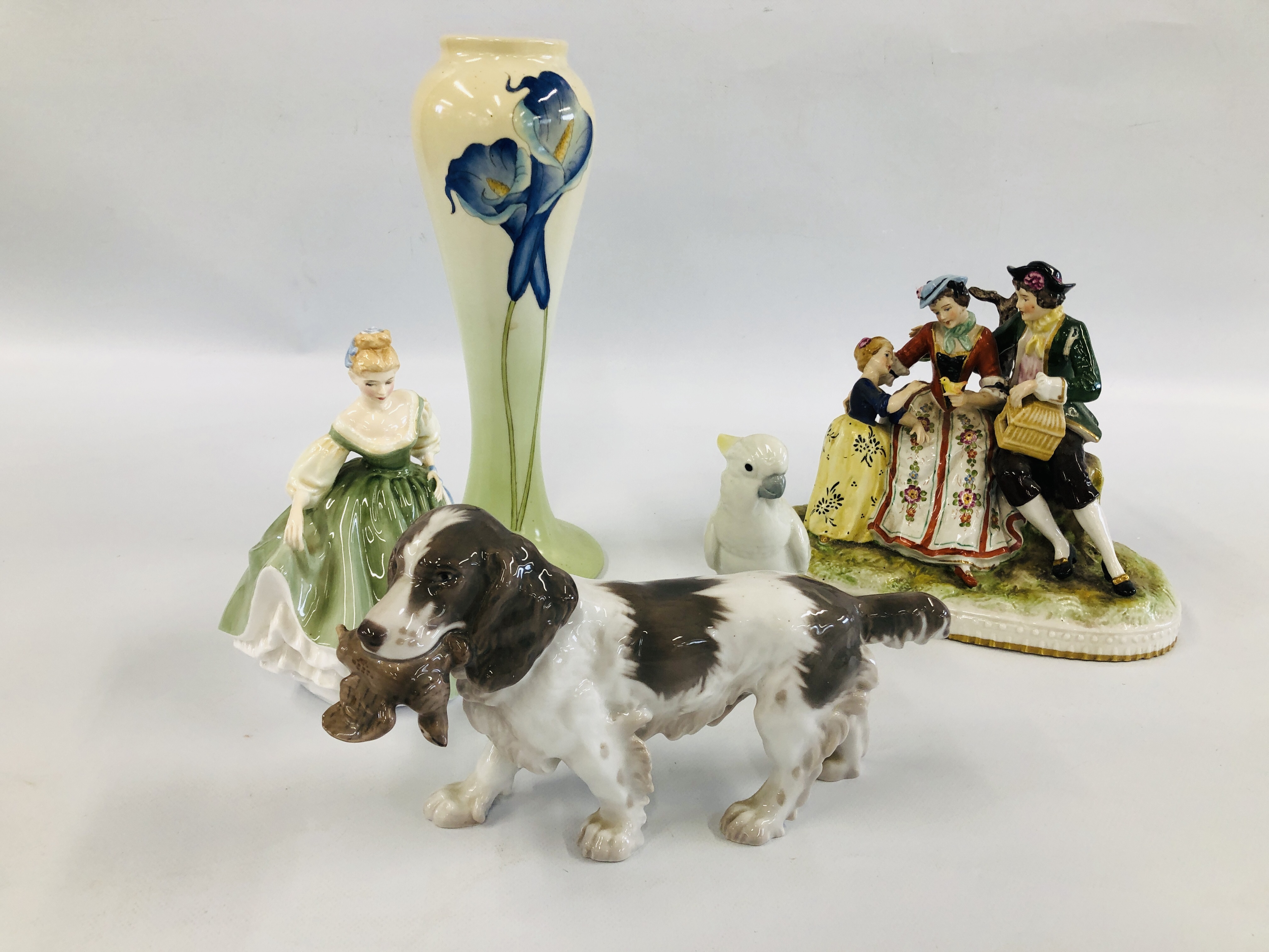 A GROUP OF 4 CABINET ORNAMENTS TO INCLUDE HUNTING SPANIEL WITH GROUSE IN IT'S MOUTH H 14CM L 26CM,