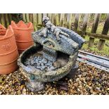 A RAISED CONCRETE COUPLE LYING UPON BRIDGE WATER FEATURE, H 60CM.