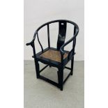 AN ORIENTAL BLACK LACQUERED ARM CHAIR WITH CARVED SYMBOL TO REAR SUPPORT.