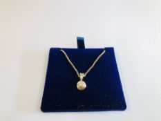 A 9CT GOLD DIAMOND PENDANT & CHAIN.