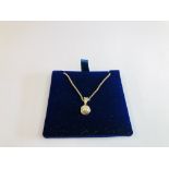 A 9CT GOLD DIAMOND PENDANT & CHAIN.