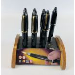 A COLLECTION OF 10 LIGHTERS IN THE FORM OF FOUNTAIN PENS IN ORIGINAL DISPLAY STAND.