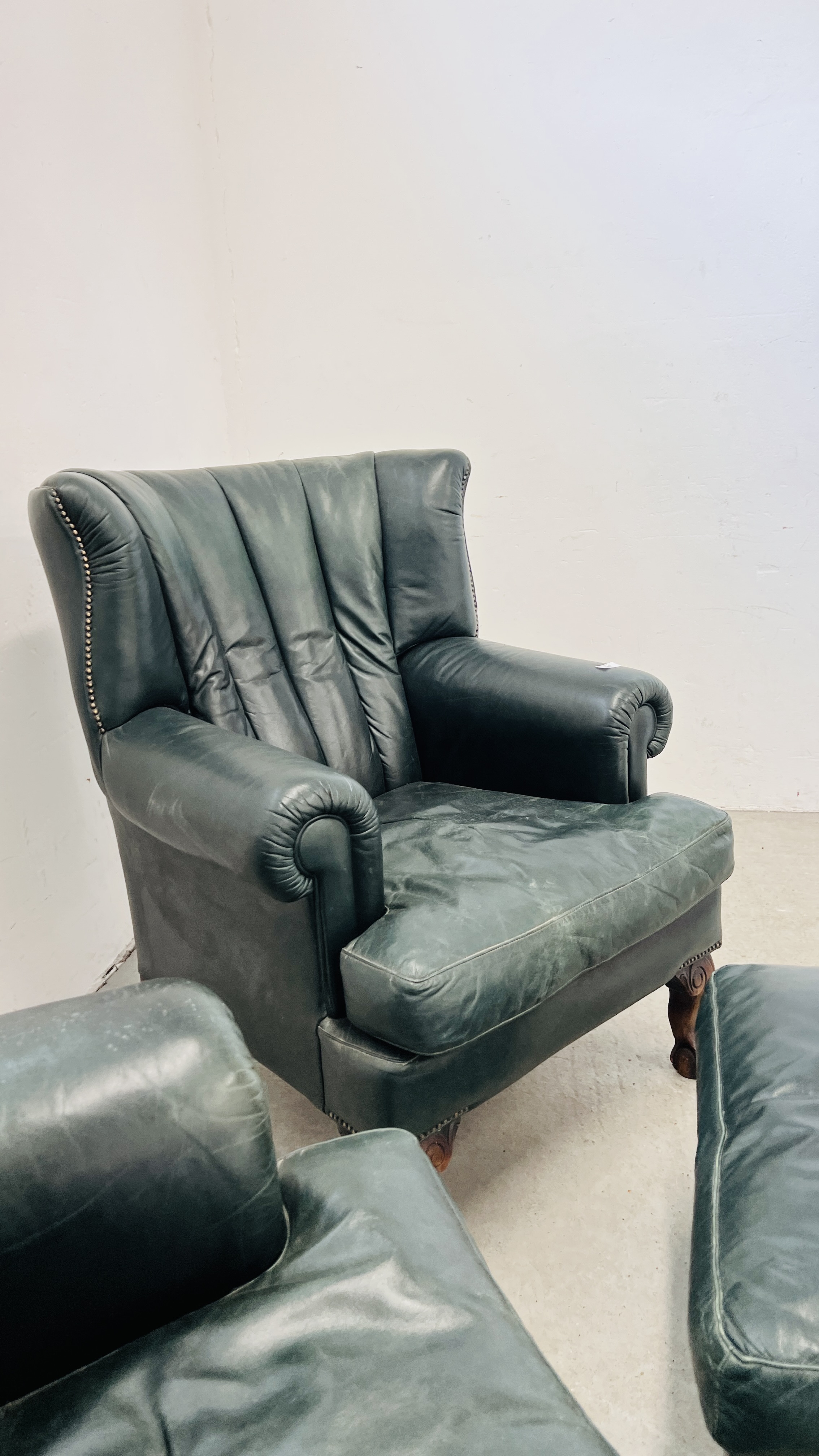 A PAIR OF MODERN BOTTLE GREEN LEATHER WING BACK FIRE SIDE ARMCHAIRS ON BALL AND CLAW FEET ALONG - Image 6 of 13