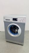 A HAIER SILVER FINISH WASHING MACHINE - SOLD AS SEEN.