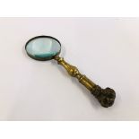 A VINTAGE BRASS MAGNIFYING GLASS, THE HANDLE HAVING SCREW TOP BULLDOG HEAD FIGURE.