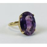 AN IMPRESSIVE 9CT GOLD RING SET WITH AN OVAL AMETHYST