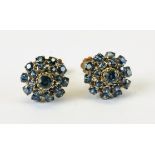 A PAIR OF SAPPHIRE SET CLUSTER SCREW ON EARRINGS, THE MOUNTS MARKED 18K.
