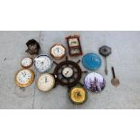A GROUP OF ASSORTED WALL CLOCKS TO INCLUDE A CUCKOO CLOCK AND A SHIP WHEEL EXAMPLE ETC.