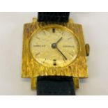 A LADIES RETRO SARCAR WRIST WATCH WITH GOLD COLOURED DIAL ON LEATHER STRAP.