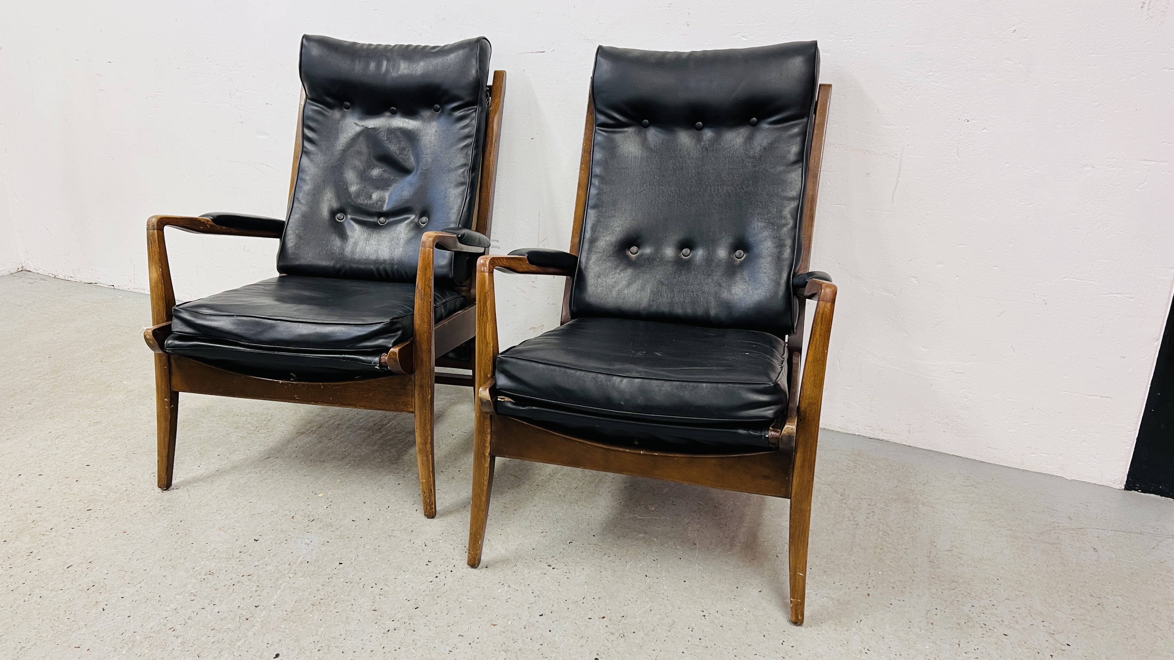 A PAIR OF RETRO CONTEMPORARY BLACK FAUX LEATHER EASY STYLE CHAIR BEARING ORIGINAL MAKERS LABEL