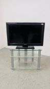 SONY 32 INCH TV MODEL KDL-3255500 ALONG WITH A MODERN 3 TIER CLEAR GLASS STAND - SOLD AS SEEN.