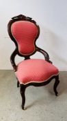 A VINTAGE MAHOGANY SPOON BACK NURSING CHAIR FINISHED IN PINK UPHOLSTERY.