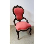A VINTAGE MAHOGANY SPOON BACK NURSING CHAIR FINISHED IN PINK UPHOLSTERY.
