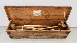 A VINTAGE PINE BOX CONTAINING CROQUET GAME.