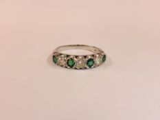 AN 18CT WHITE GOLD EMERALD AND DIAMOND HALF HOOP ETERNITY RING.