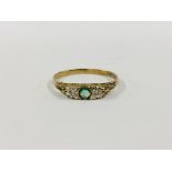 A 9CT GOLD TWO STONE DIAMOND RING SET WITH A CENTRAL GREEN STONE.