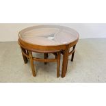 A MID CENTURY CIRCULAR GLASS TOP TABLE WITH THE ADDITIONAL 3 OVAL PULL OUT TABLES.