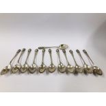 A SET OF TWELVE PERUVIAN SILVER COFFEE SPOONS WITH MASK HANDLES.