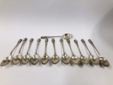 A SET OF TWELVE PERUVIAN SILVER COFFEE SPOONS WITH MASK HANDLES.