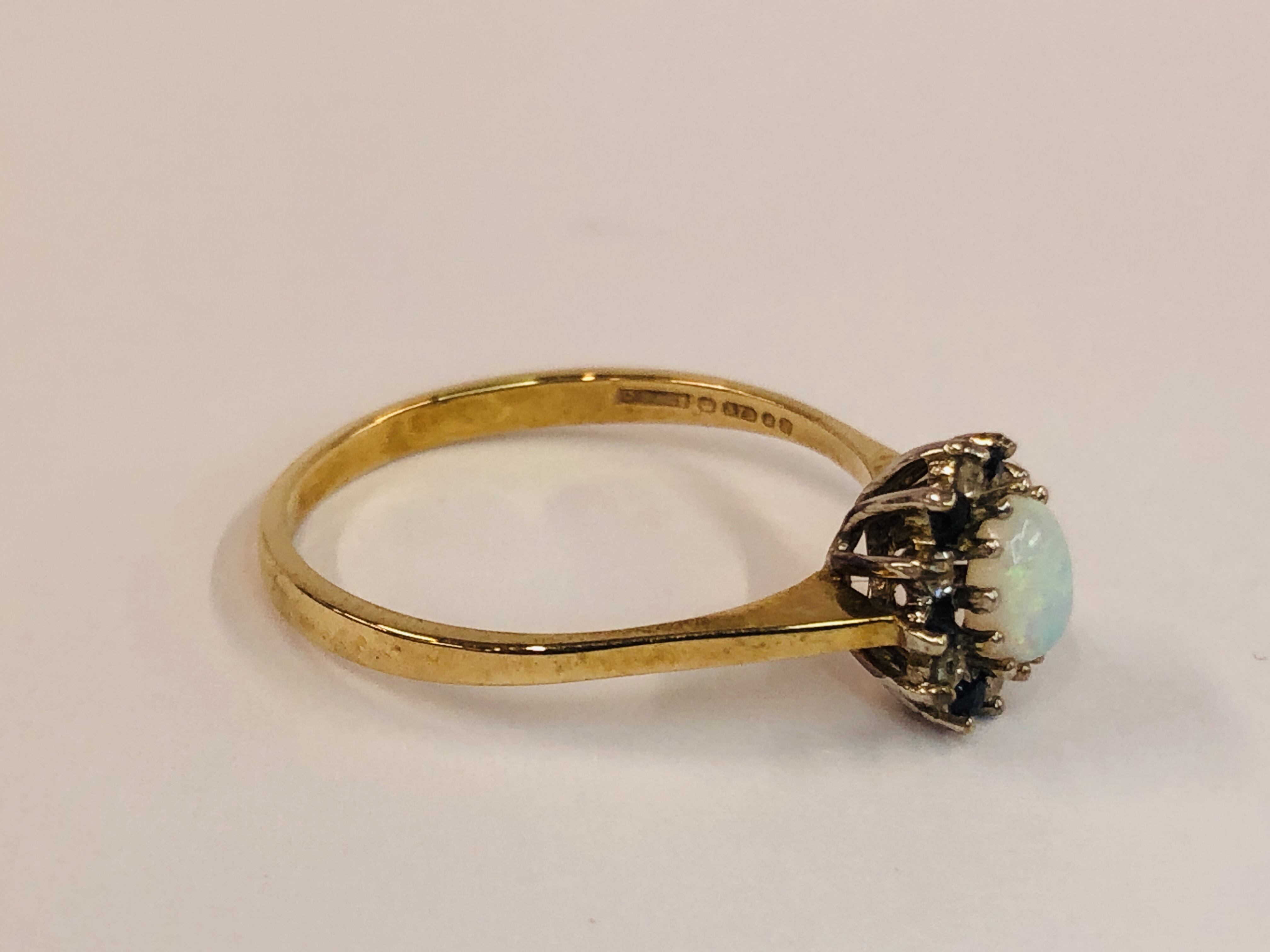 A 9CT GOLD RING SET WITH CENTRAL OVAL OPAL, SURROUNDED BY SMALLER DIAMONDS AND SAPPHIRES. - Image 4 of 9