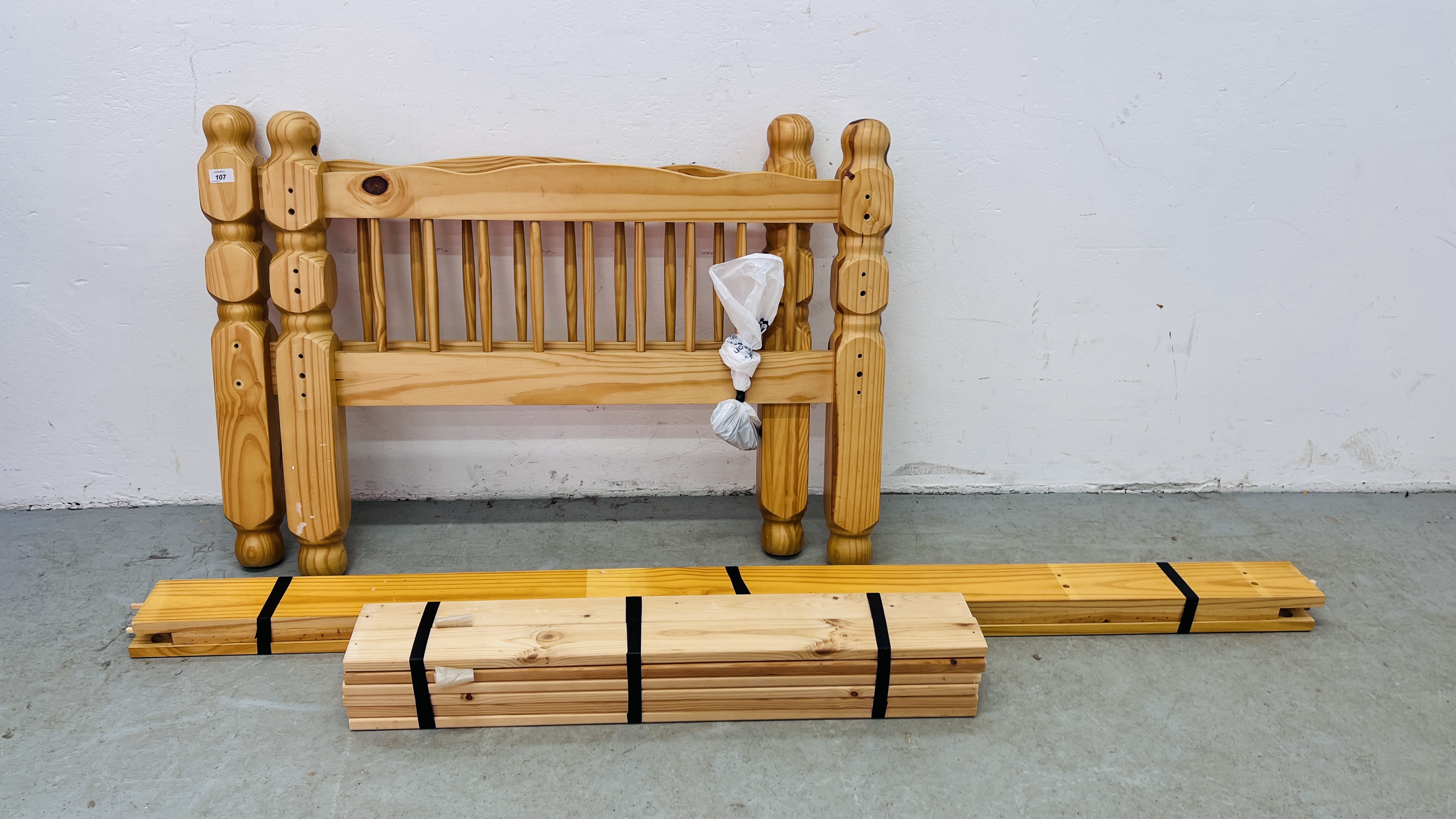 A SINGLE PINE BED FRAME.