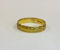 A 9CT GOLD WEDDING BAND.