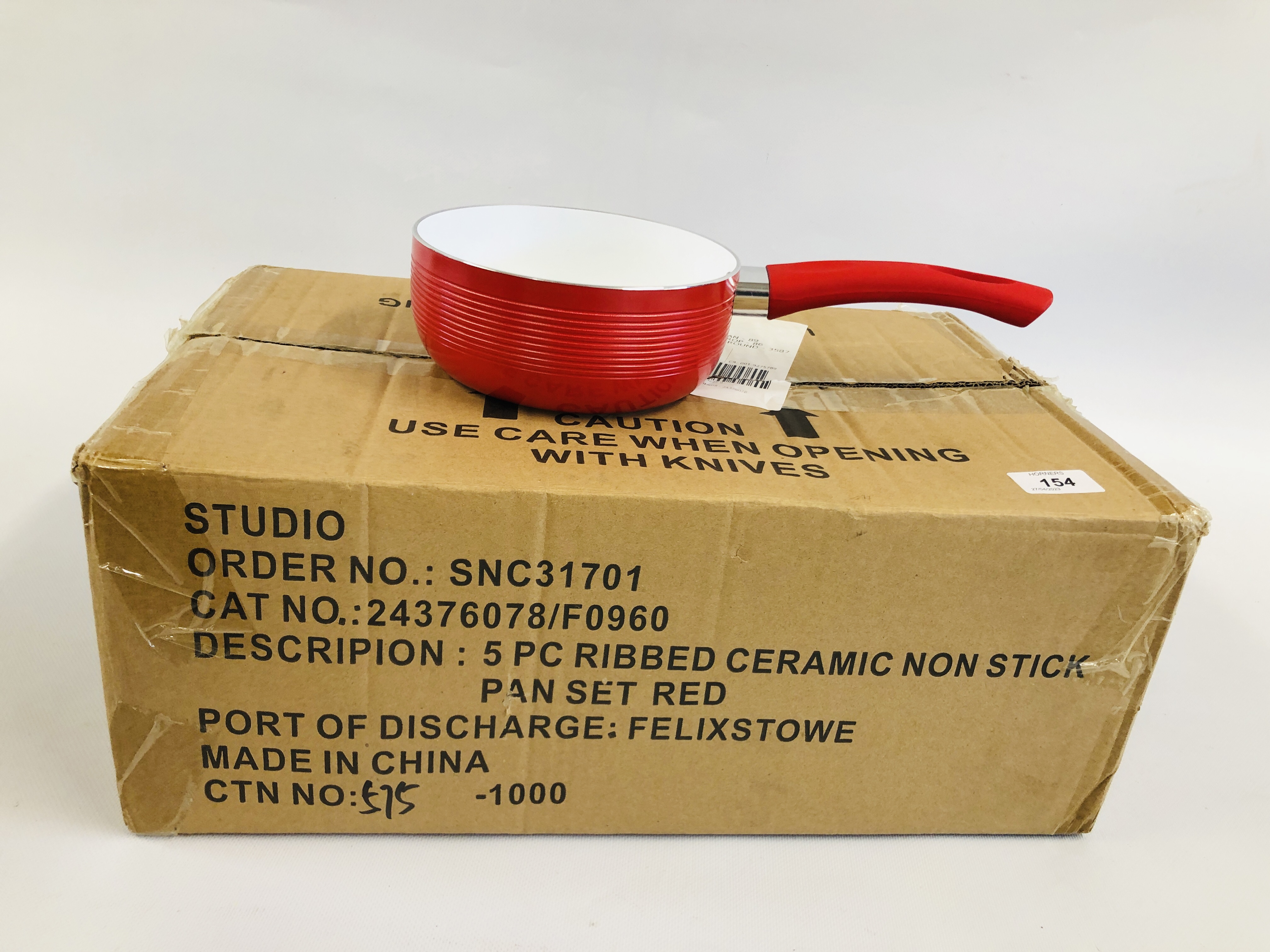 A BOXED AS NEW "STUDIO" 5 PIECE RIBBED CERAMIC NON STICK PAN SET, IN A RED FINISH.