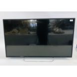 A BAIRD 42" FLAT SCREEN TV WITH REMOTE - SOLD AS SEEN.