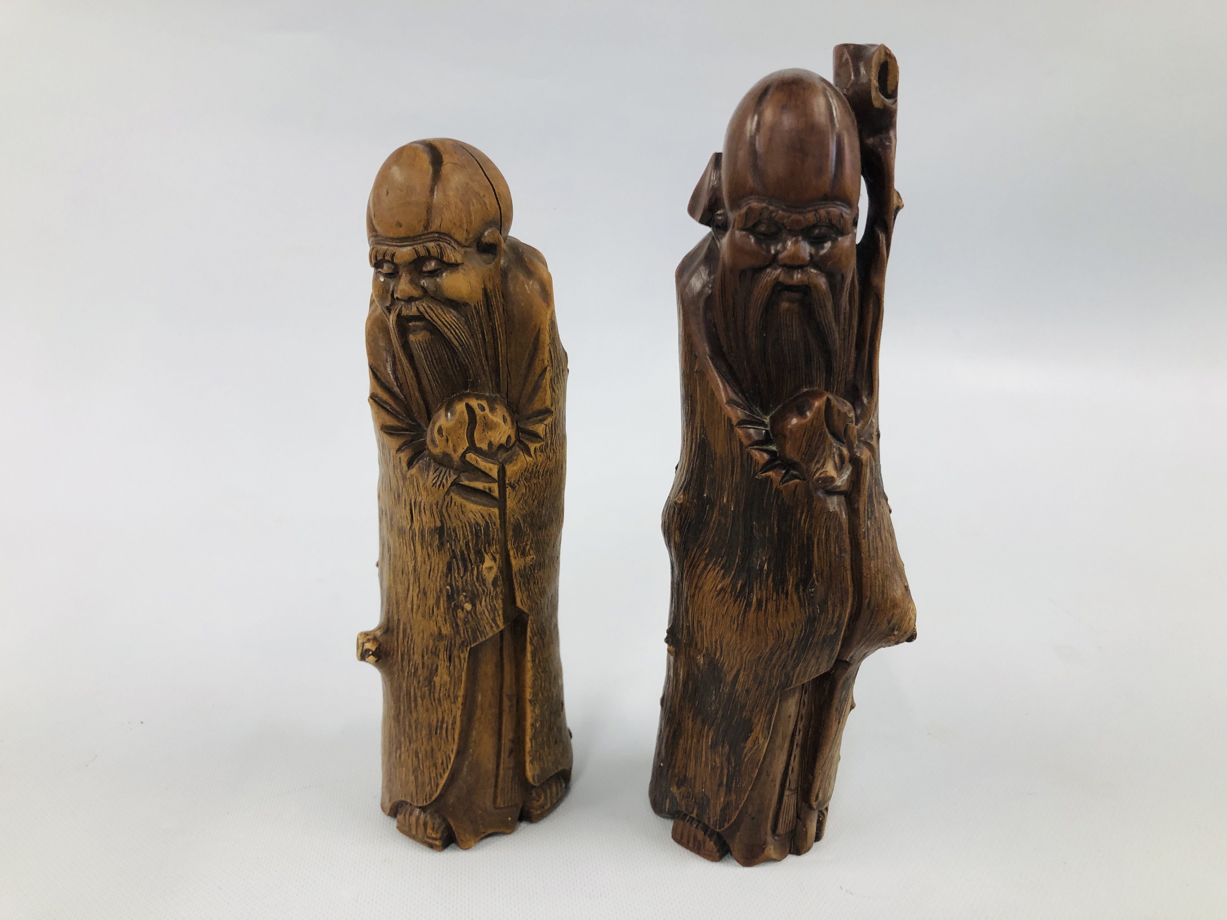 TWO C19TH CHINESE HARDWOOD CARVINGS OF ELDERS, 30CM AND 27CM HIGH.