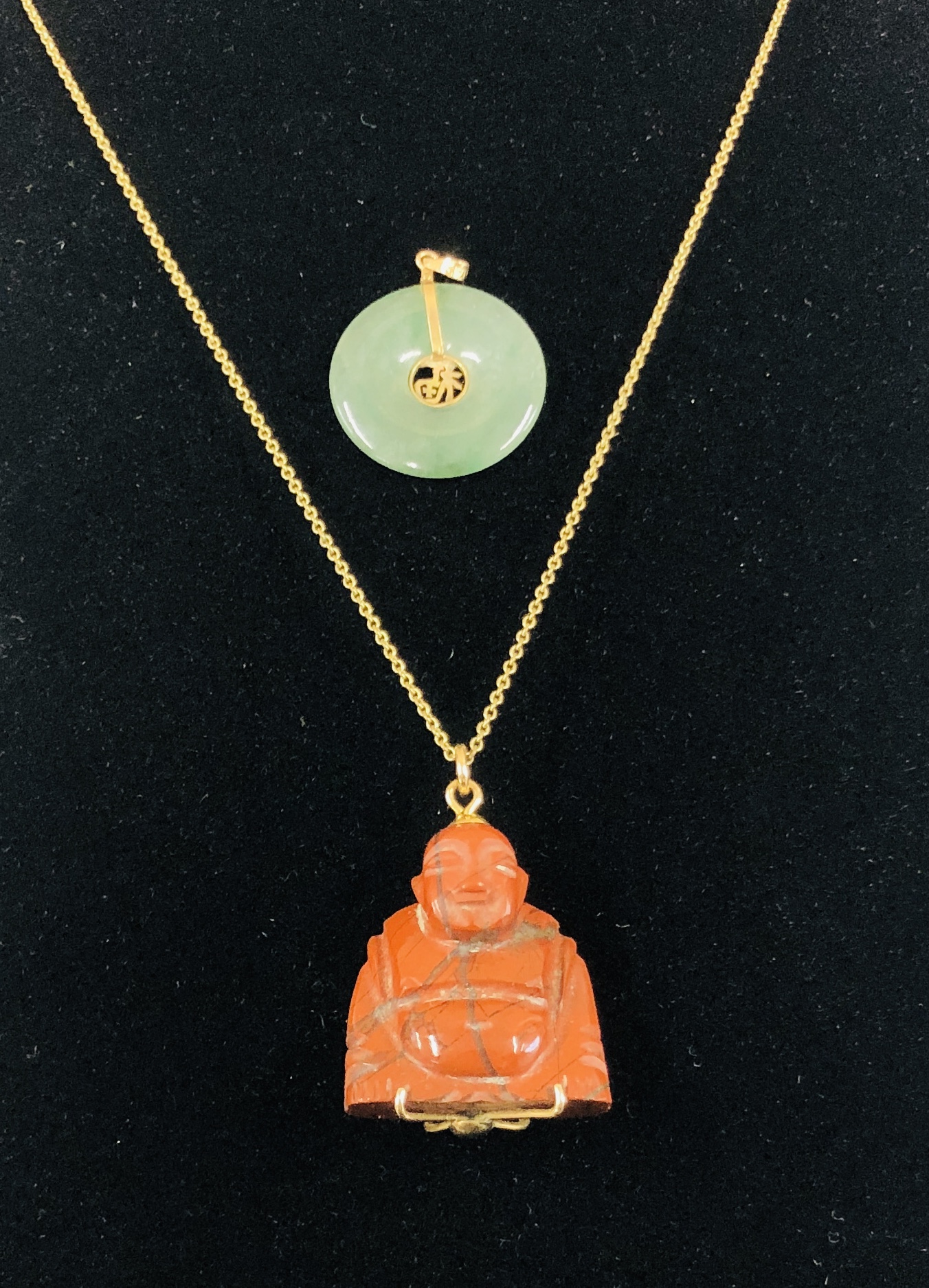 A JADE PENDANT MARKED 585 TO THE BACK ALONG WITH BUDDHA PENDANT.