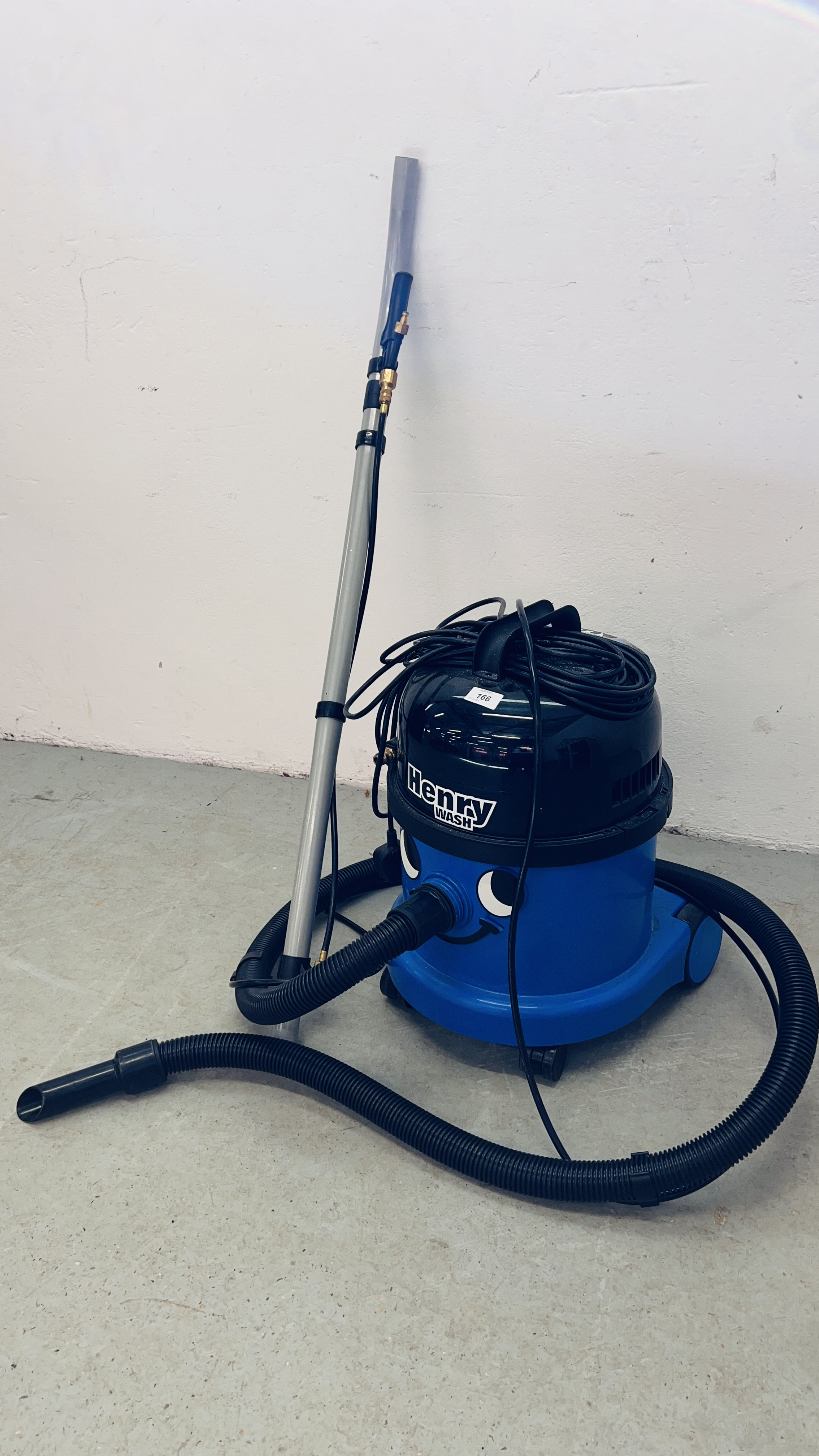 A NUMATIC "HENRY WASH" WET AND DRY VACUUM CLEANER WITH ACCESSORIES - SOLD AS SEEN.