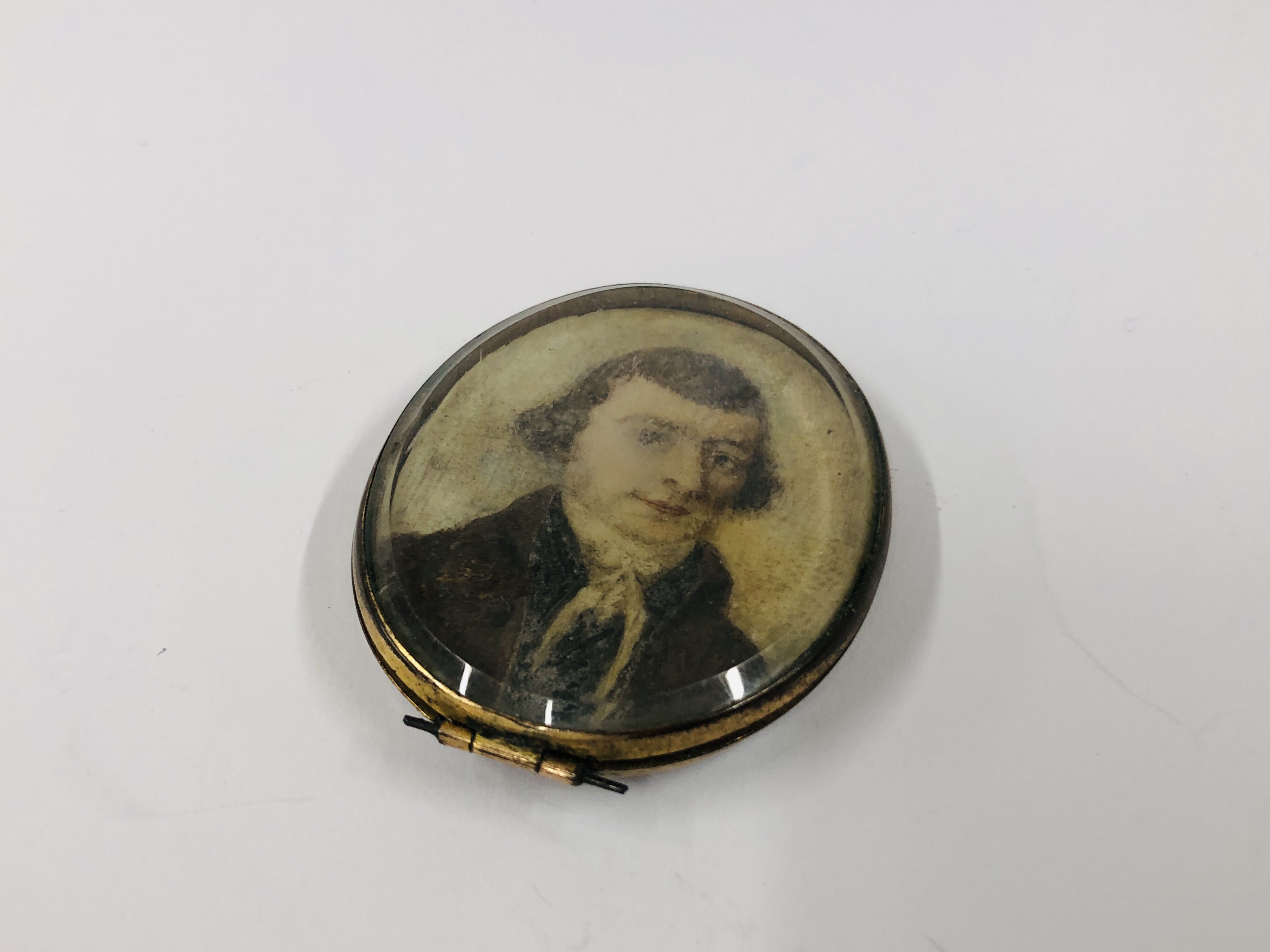 A GEORGIAN HAND PAINTED MINIATURE PORTRAIT ON IVORY.