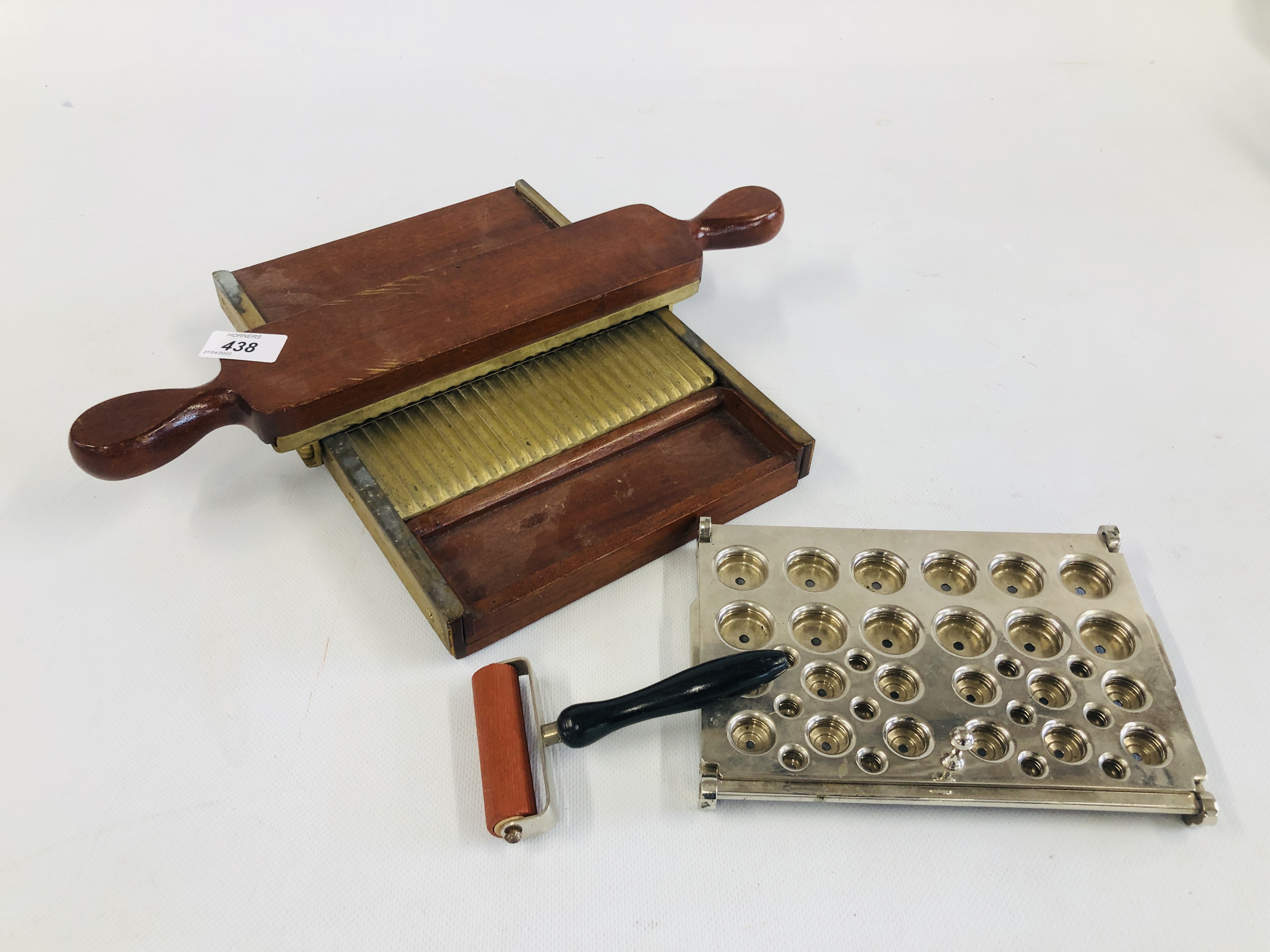 A VINTAGE WOODEN AND BRASS PILL PRESS ALONG WITH A FURTHER STAINLESS STEEL EXAMPLE AND A SMALL