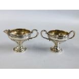 A DECORATIVE CREAM JUG AND MATCHING TWO HANDLED SUGAR BOWL MARKED "CROWN" STERLING.